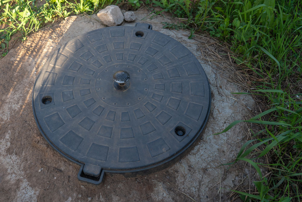 Close-up of a residential well lid cover installed on a property in Portage County, OH